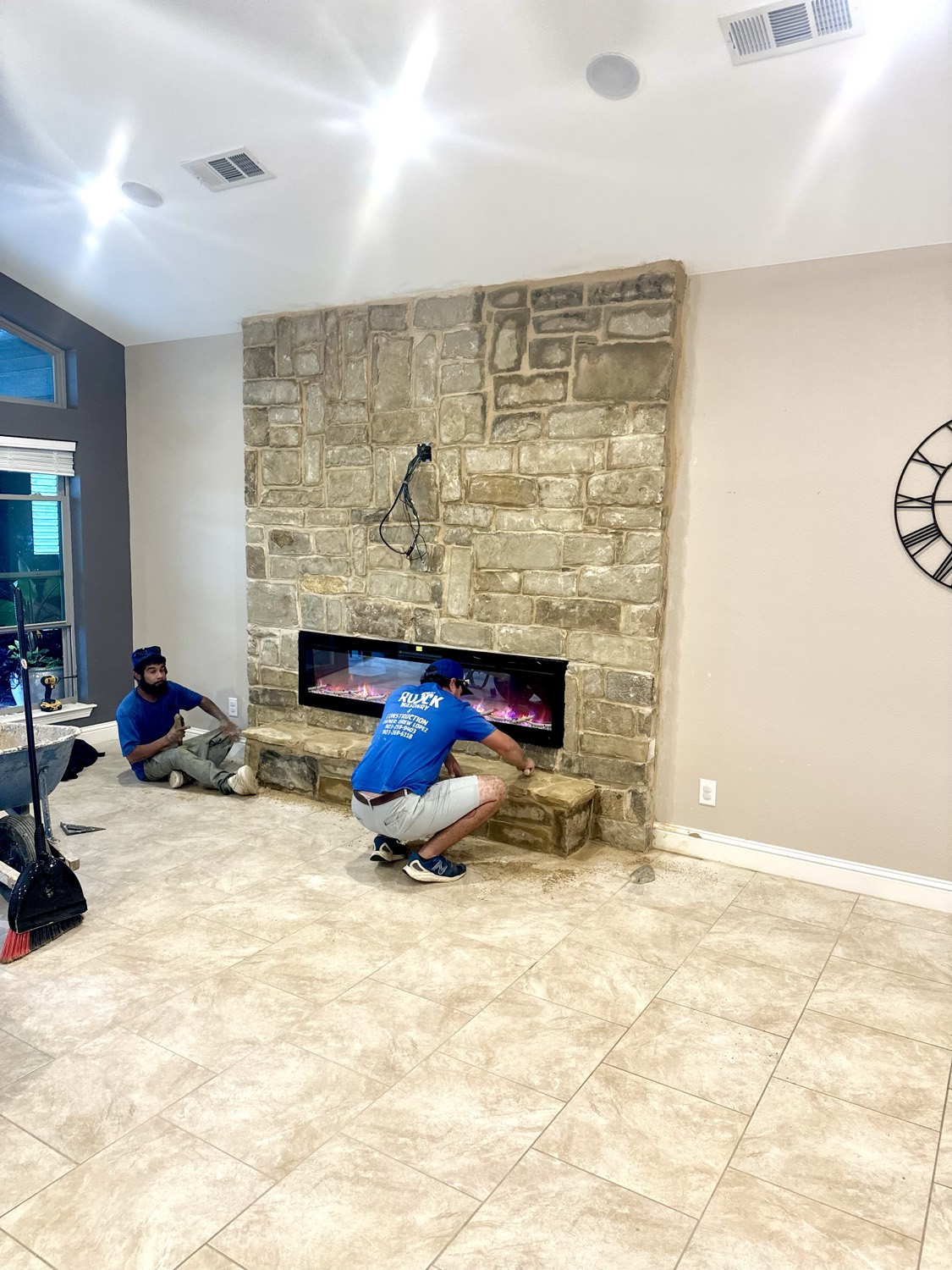 3rd Rock Masonry crew working on a stone fireplace and chimney