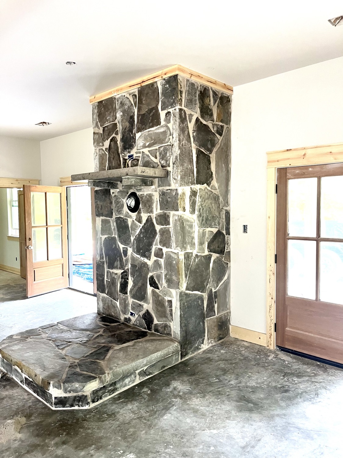 Floor-to-ceiling stone fireplace built by 3rd Rock Masonry